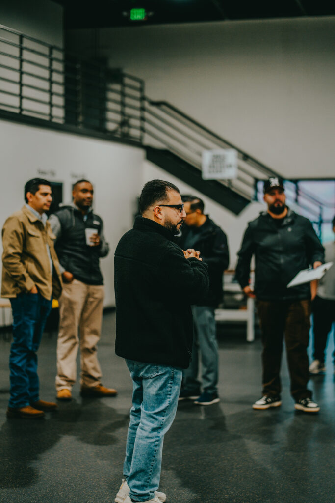 Men gathering speaking with each other.